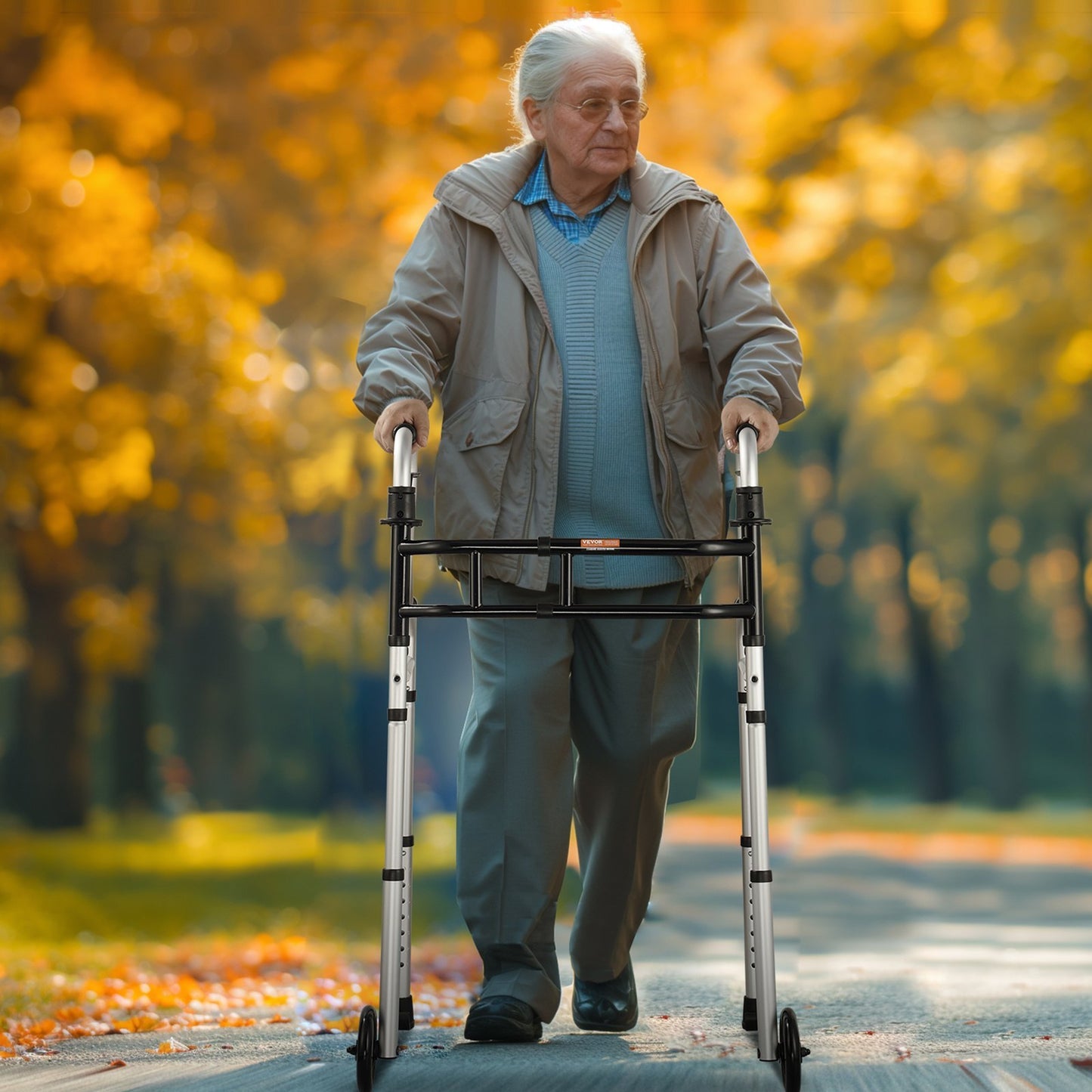 older man walking in an autumn park using a folding walker with stand-assist handholds