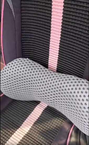 Lumbar support cushion mounted on a car seat, shows fit and straps
